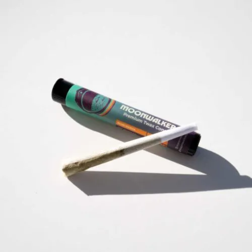 Moonwalker topical cream and pre-rolled herbal joint for relaxation on a clean background.