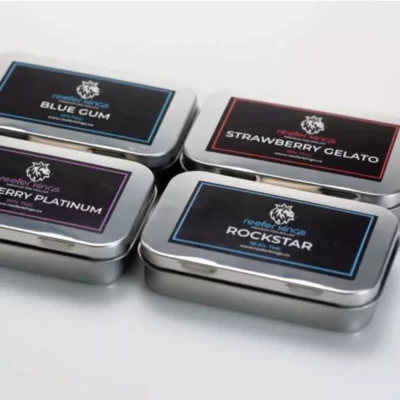 Reefer Kings THC Preroll Tins with assorted flavors on white background.