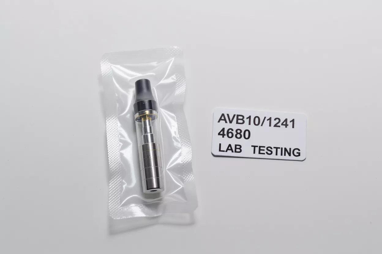 Vape cartridge in plastic packaging next to a 'LAB TESTING' label.