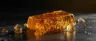 close-up of a golden shatter bar cannabis concentrate slab