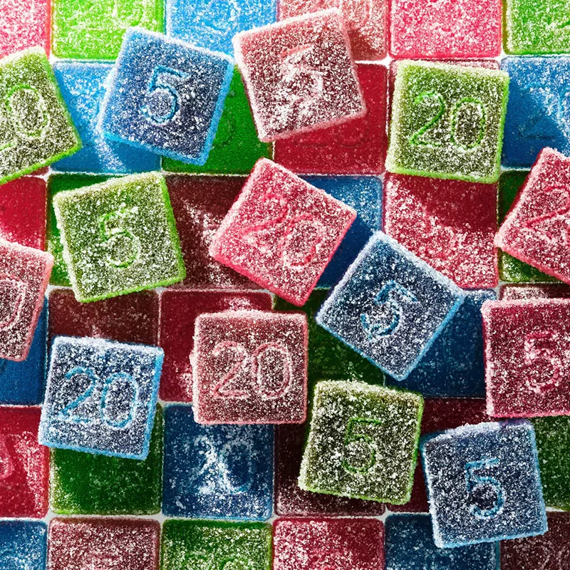 Assorted 5 and 20-point sugar-coated gummy candies in red, green, blue, and purple.