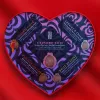Heart-shaped chocolate box with colorful designs and various gourmet chocolate descriptions.