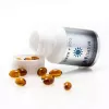 Birch+Fog Sativa CBD/THC capsules, amber gel caps spilling from white bottle.