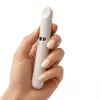 Hand holding a sleek, white device with a rounded top.