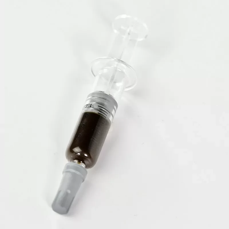 Syringe with dark medical liquid on white, possibly for specialized use or research.