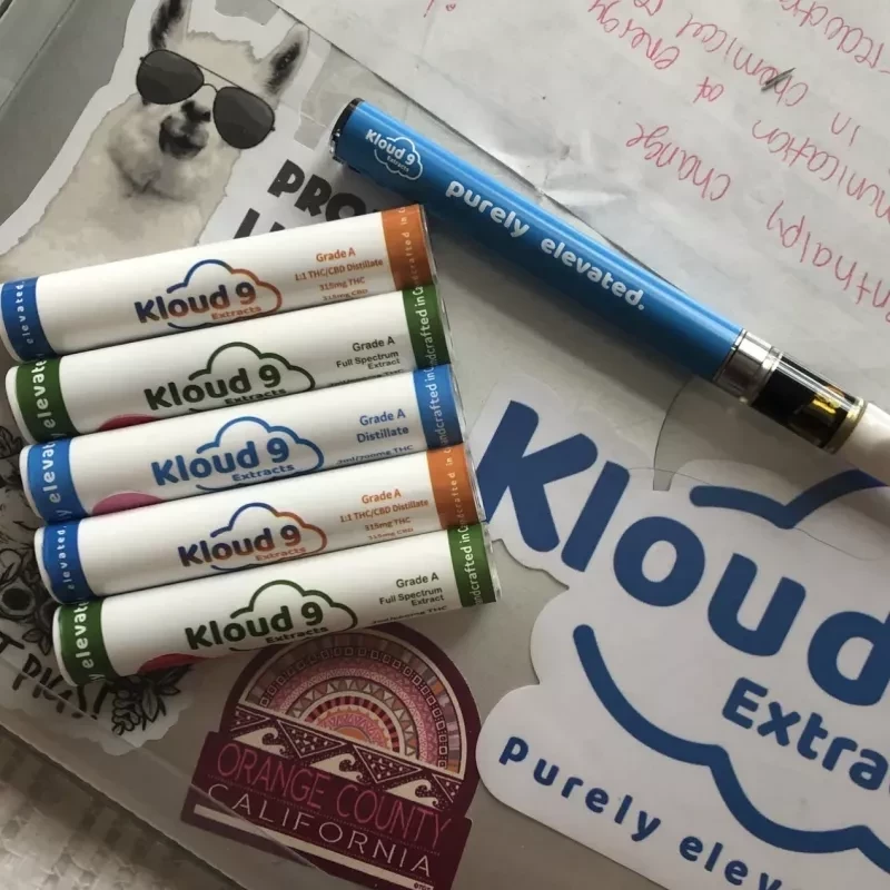 Kloud9 Extracts vape pen and assorted full spectrum distillate cartridges with flavor indicators.