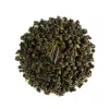 Oolong tea leaves with a golden supplement capsule, representing health and wellness.