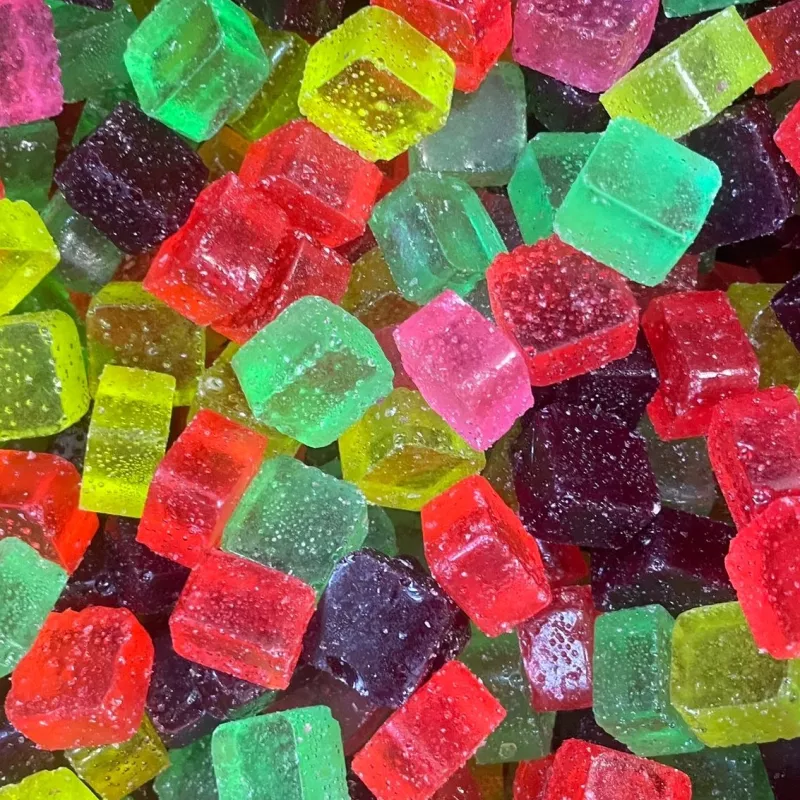 Assorted colorful gummy cube candies with sugar coating.