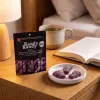 Kandy Kandy grape gummies and packaging on a bedside table.