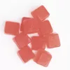Red THC gummies with embossed triangular symbols on a white background.