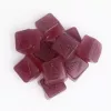 THC gummy cubes, reddish-brown, embossed logo, chewy, fruit-flavored, glossy surface.