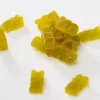 Yellow gummy bears on white background.