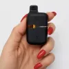 Black Liift Honey vape in a hand with red nails