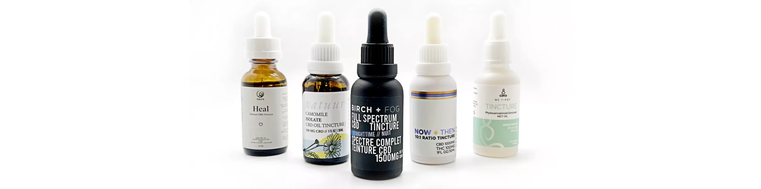 Assortment of five CBD tincture bottles for health and sleep, displayed on a white surface.