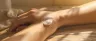 Jar of transdermal relief cream with cannabinoid formula being applied to skin