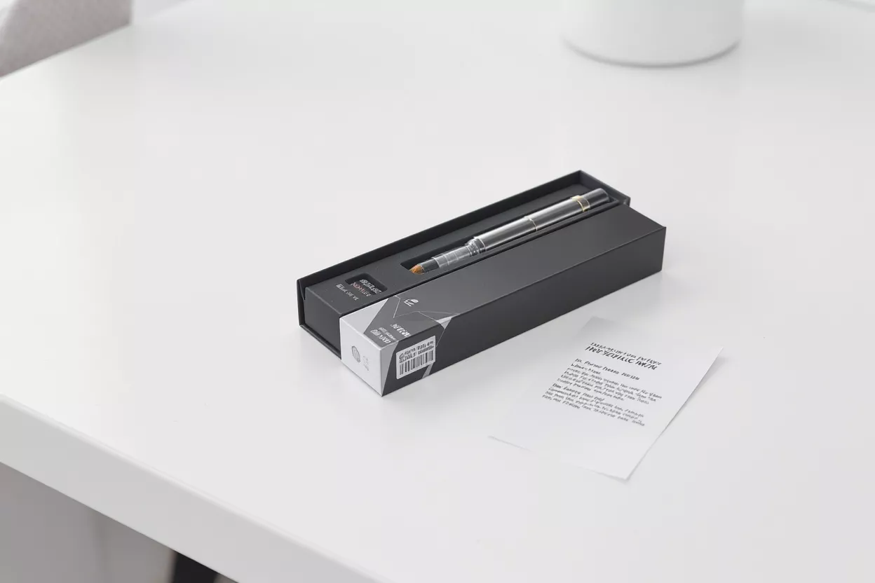 A sleek pen set in a black box on a white table