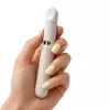 A hand with yellow nail polish holds a light gray vape device.