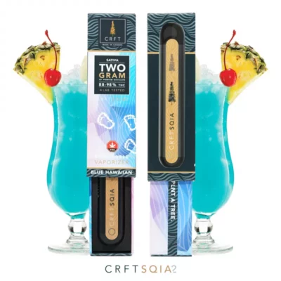 CRFT Blue Hawaiian Sativa 2g THC vape pens with eco-friendly initiative beside tropical drinks.