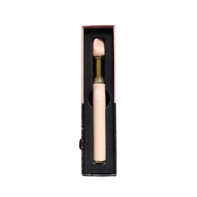Luxurious pink lipstick with golden detail and heart emblem in sophisticated black packaging.
