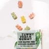 Vegan CBD gummies with colorful bear shapes on a white surface.