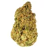 Close-up of a frosty, colorful, well-trimmed cannabis bud with trichomes, pistils, and hues of green, orange, and purple.