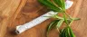 A thin pinner joint rolled with cannabis flower