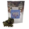 Silver pouch with blue label, cannabis buds beside it, labeled northern kush.